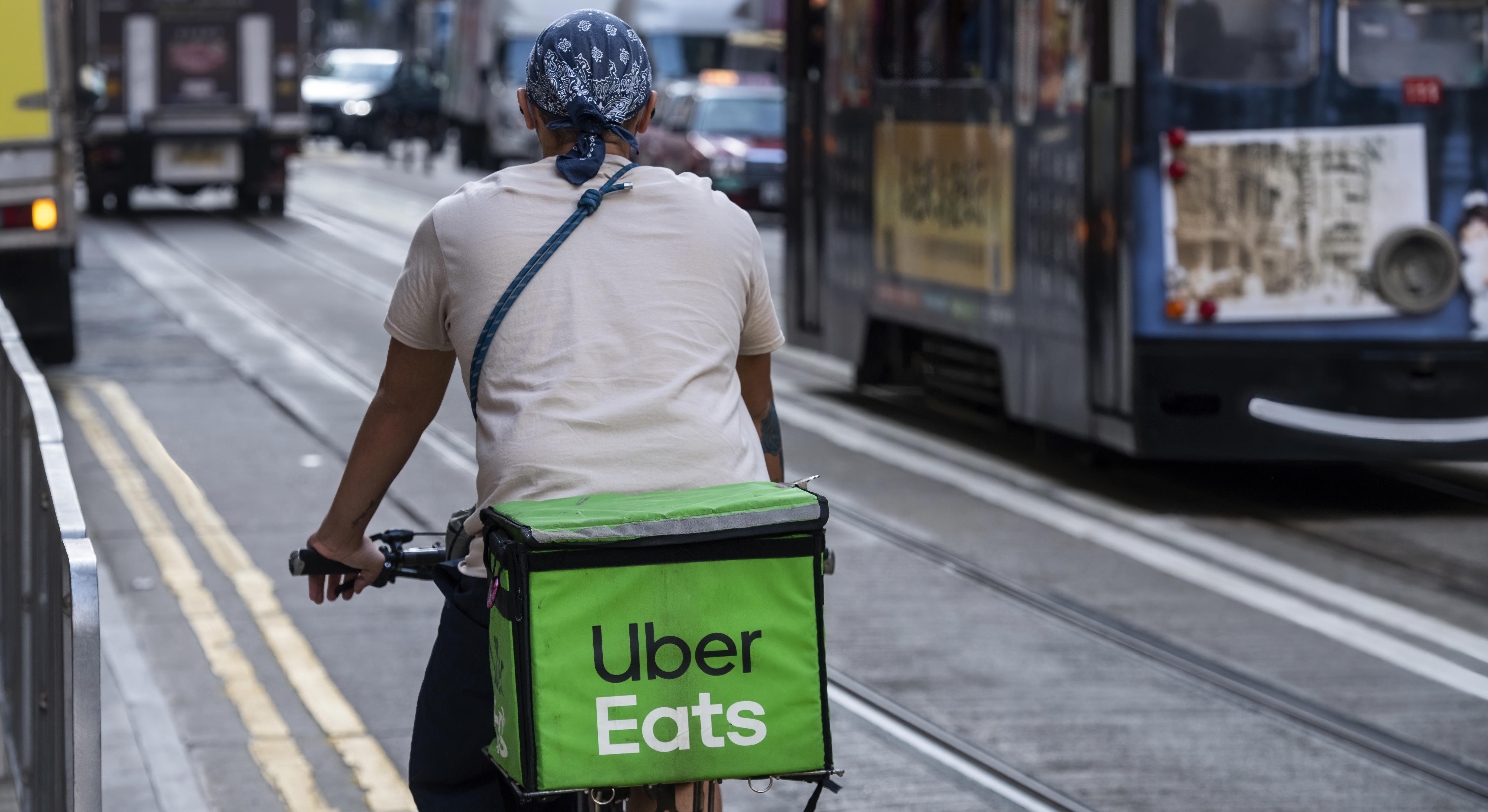 A delivery worker from the delivery take out food company Uber Eats is seen riding on a bicycle in Hong Kong