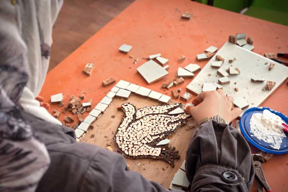 Woman crafting a white dove.