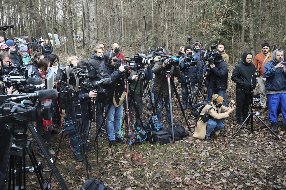 Many media persons are seen gathered at a press conference in a wooded area near Kuznica, Poland on 12 November, 2021.